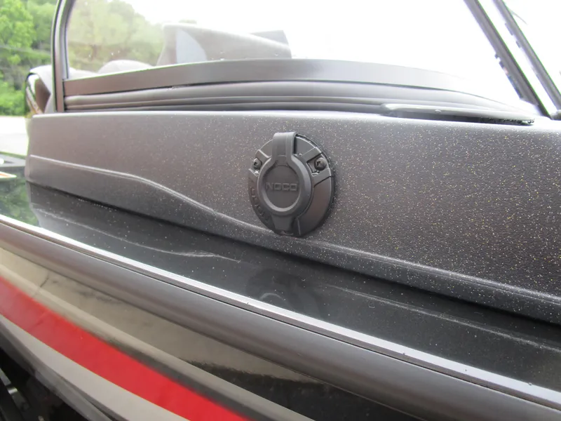 Slide: The Image of 2026 Tracker Targa 18 WT boat detail with sleek black finish and NOCO plug. - 20