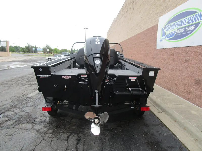 Slide: The Image of 2026 Tracker Targa 18 WT boat with outboard motor, parked at Grand Pointe Marina. - 6