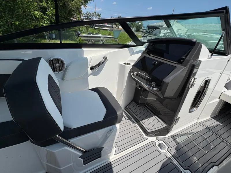 Slide: The Image of Interior of a 2020 Monterey M65 boat featuring sleek seating and modern dashboard controls. - 12