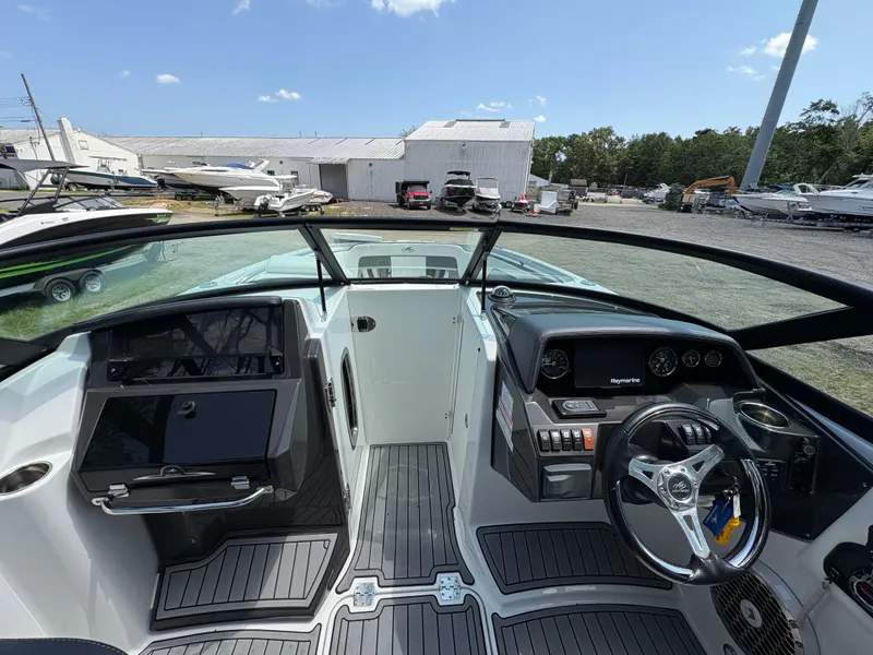 Slide: The Image of Cockpit view of 2020 Monterey M65 boat with modern dashboard and steering wheel. - 2