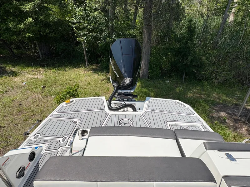 Slide: The Image of Rear view of a 2020 Monterey M65 boat with outboard motor, surrounded by lush greenery. - 5