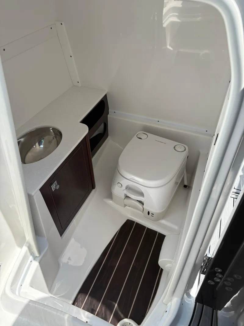 Slide: The Image of Compact bathroom in 2020 Monterey M65 boat with toilet, sink, and storage cabinet. - 8