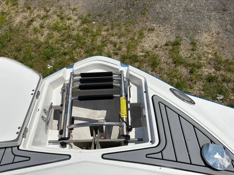Slide: The Image of 2020 Monterey M65 boat ladder compartment with stainless steel ladder and deck details. - 9