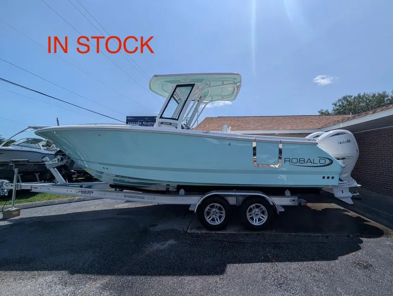 The Image of 2025 Robalo R250 Center Console boat on trailer, in stock, sunny day. - 1