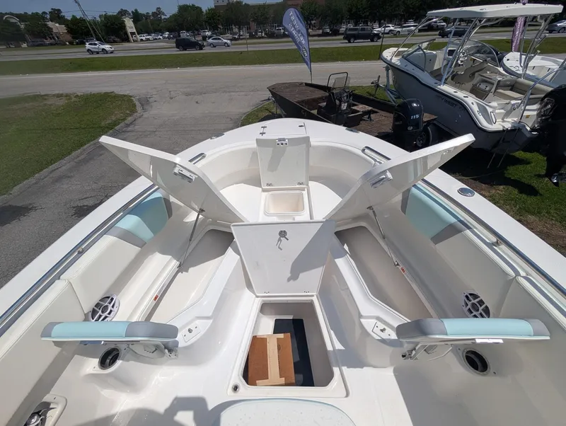 Slide: The Image of 2025 Robalo R250 Center Console boat with open storage compartments and seating. - 12