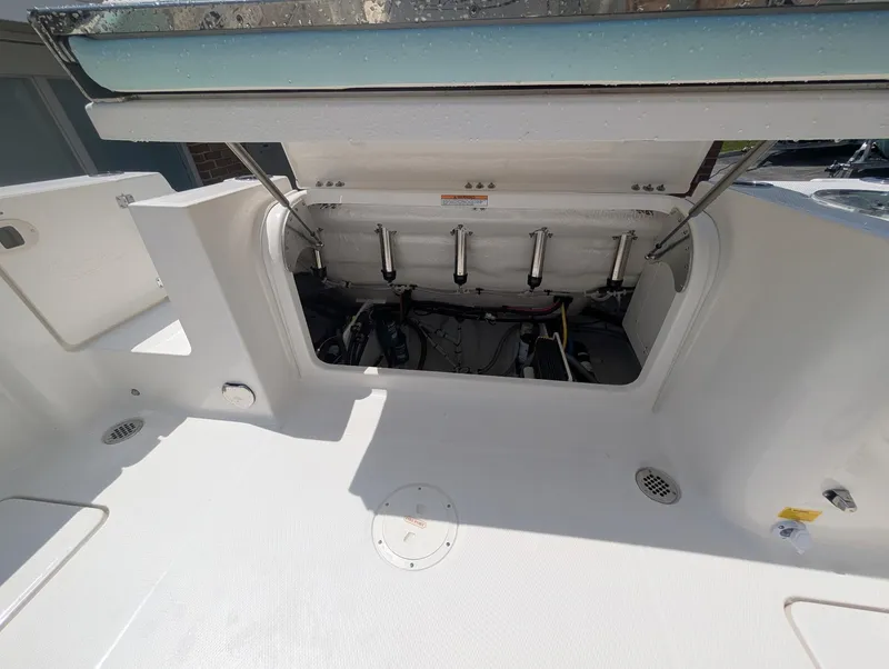 Slide: The Image of 2025 Robalo R250 Center Console boat with open engine compartment. - 14
