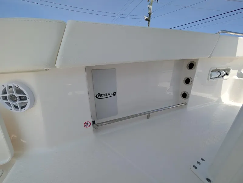 Slide: The Image of 2025 Robalo R250 Center Console boat interior with speaker and storage compartment. - 18
