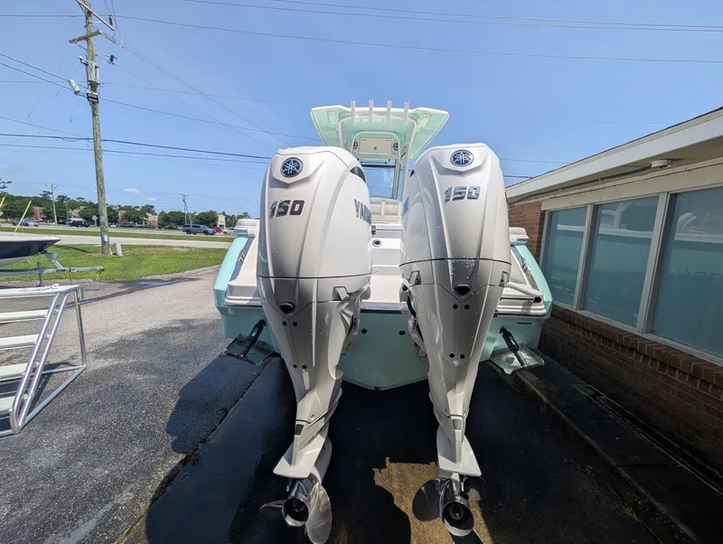 Slide: The Image of 2025 Robalo R250 Center Console boat with dual Yamaha 150 outboard engines. - 4