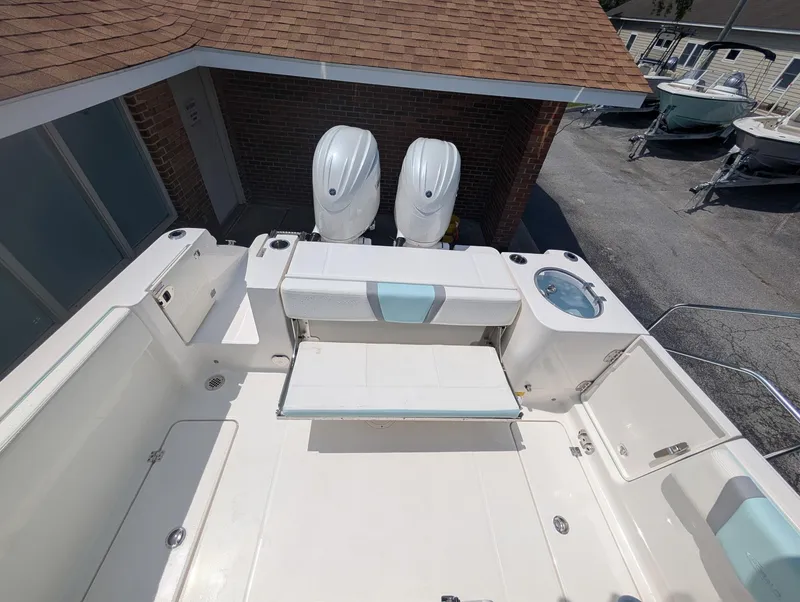 Slide: The Image of 2025 Robalo R250 Center Console boat with dual engines and spacious deck layout. - 6