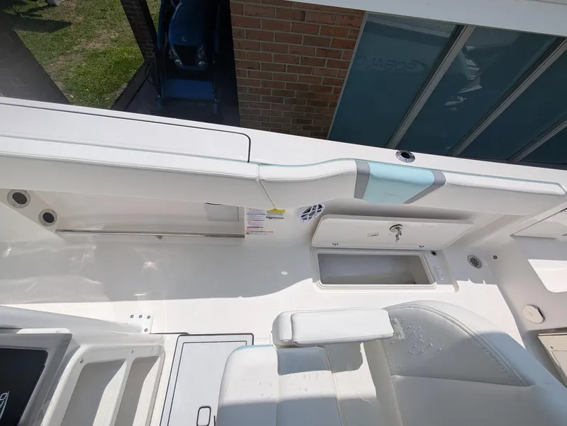 Slide: The Image of 2025 Robalo R250 Center Console boat interior with storage compartments and seating. - 5