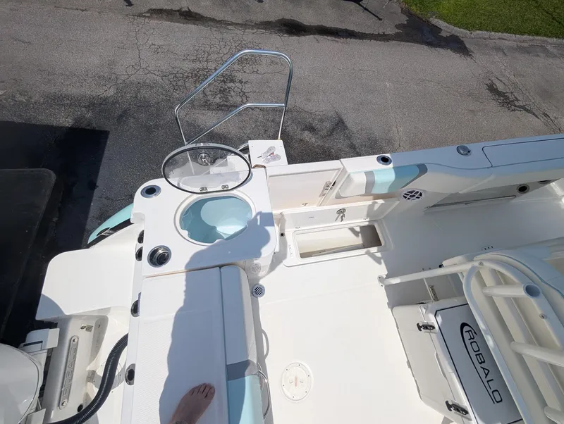 Slide: The Image of 2025 Robalo R250 Center Console boat deck with seating and storage compartments. - 7