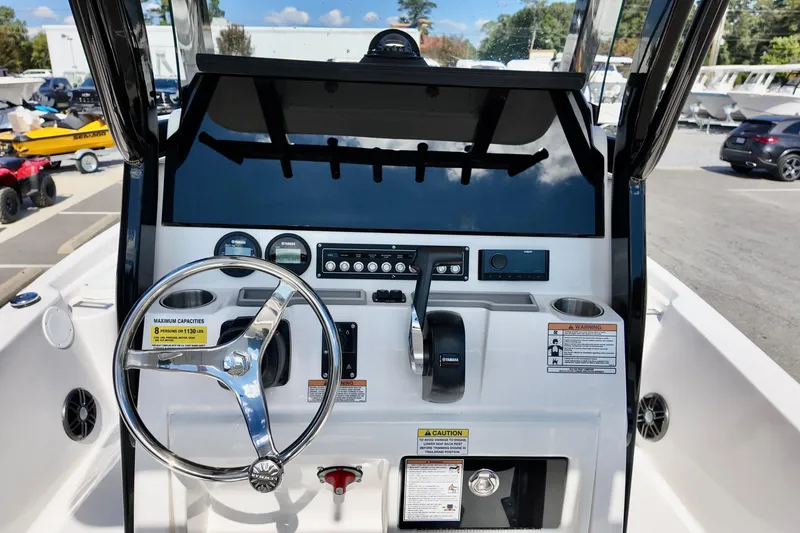 Slide: The Image of 2026 Sea Fox 231 Bay Fox boat dashboard with steering wheel and controls. - 12