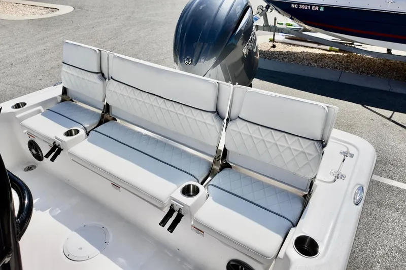 Slide: The Image of 2026 Sea Fox 231 Bay Fox boat with cushioned seating and cup holders. - 13