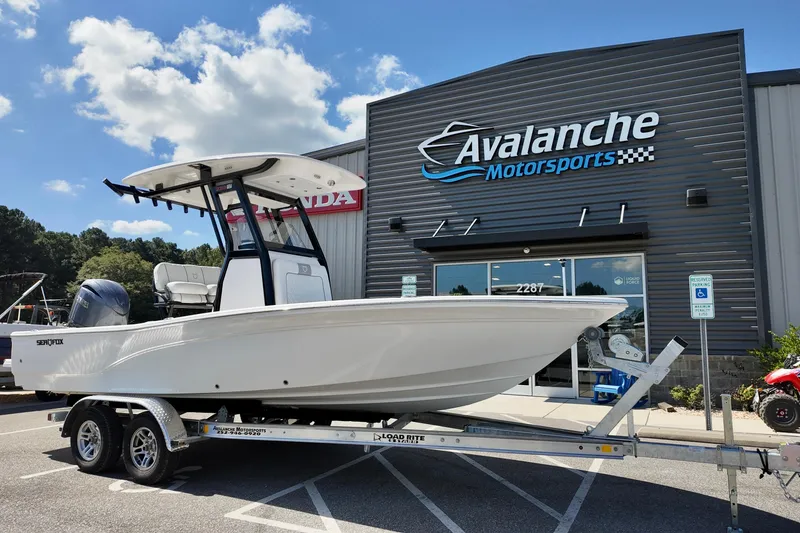 The Image of 2026 Sea Fox 231 Bay Fox boat on trailer at Avalanche Motorsports dealership. - 2