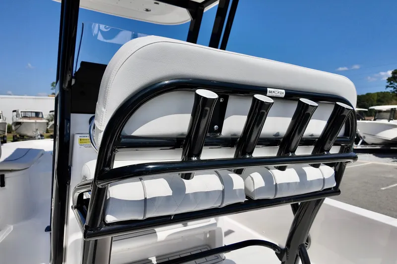 Slide: The Image of 2026 Sea Fox 231 Bay Fox boat seat with rod holders, outdoor setting. - 21