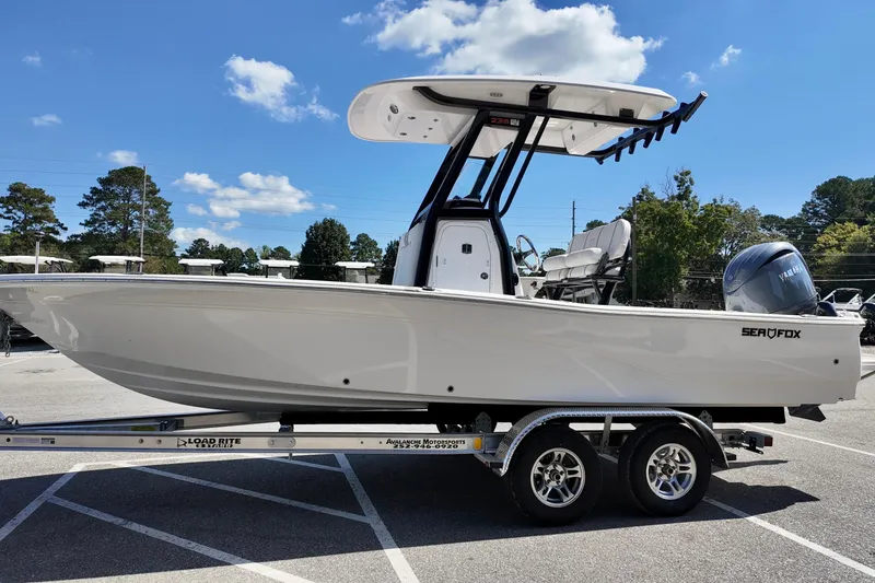 Slide: The Image of 2026 Sea Fox 231 Bay Fox boat on trailer under clear blue sky. - 5