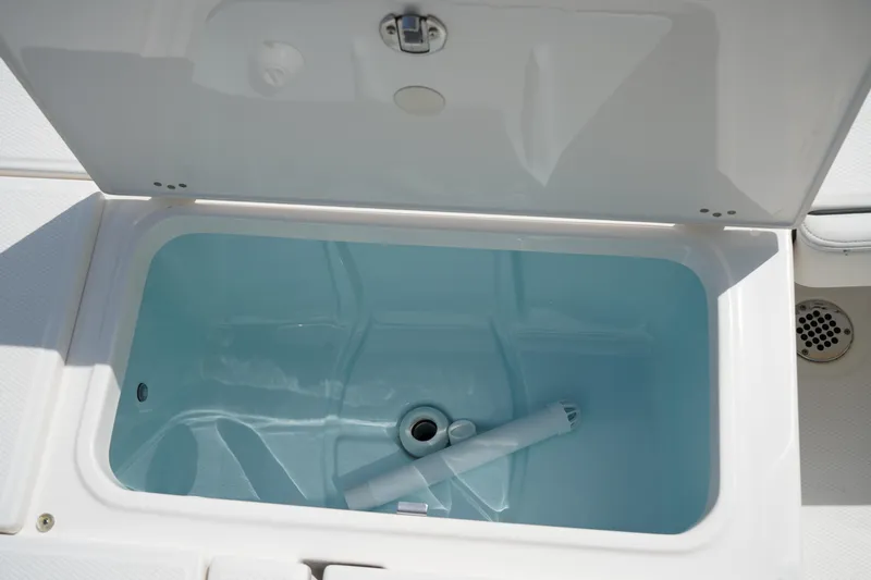 Slide: The Image of Livewell compartment on 2024 Robalo 226 Cayman boat, open lid, clean interior. - 12
