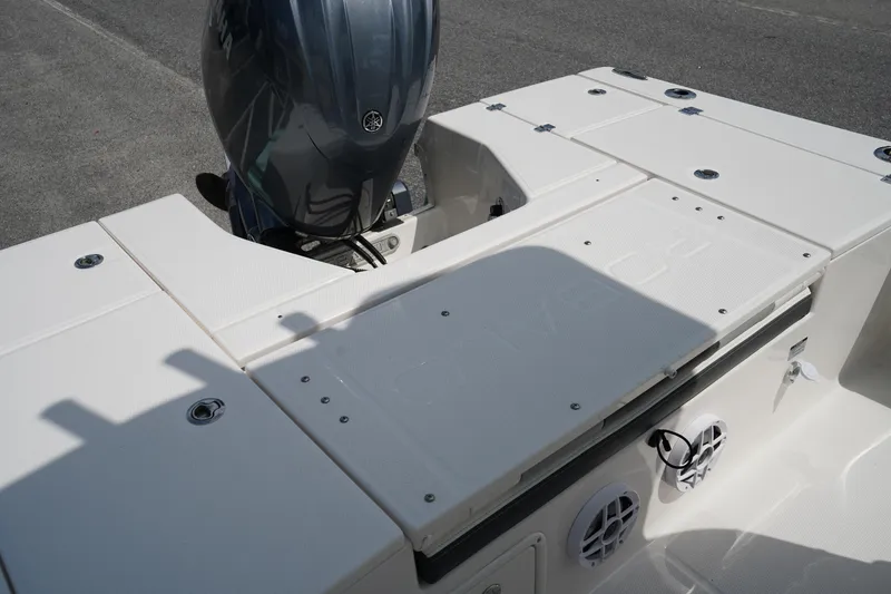 Slide: The Image of 2024 Robalo 226 Cayman boat deck with Yamaha outboard motor, featuring white seating and speakers. - 14
