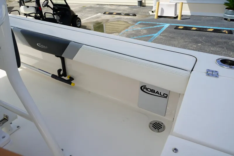 Slide: The Image of 2024 Robalo 226 Cayman boat interior with seating and storage compartment. - 16