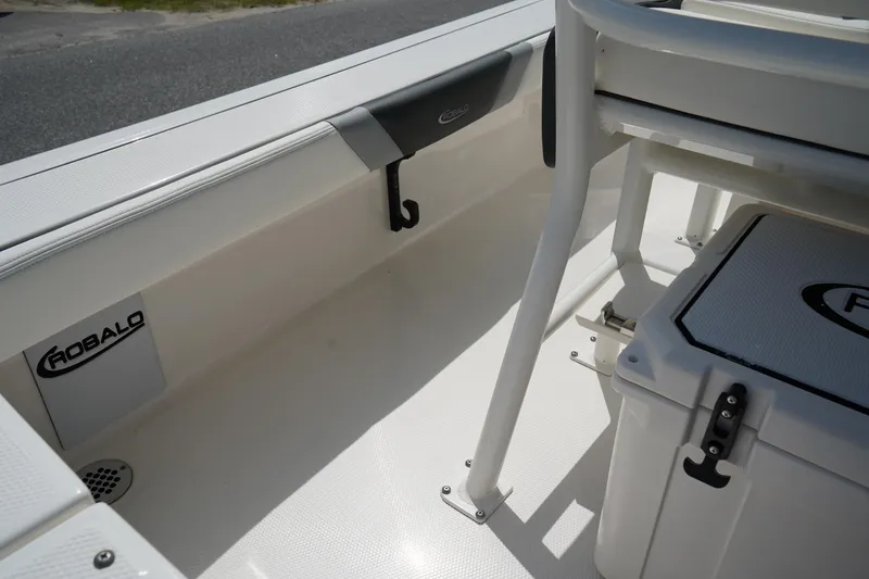 Slide: The Image of 2024 Robalo 226 Cayman boat interior, featuring seating and storage compartments. - 17