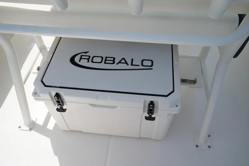 Slide: The Image of 2024 Robalo 226 Cayman boat cooler under seat, featuring secure latches. - 18