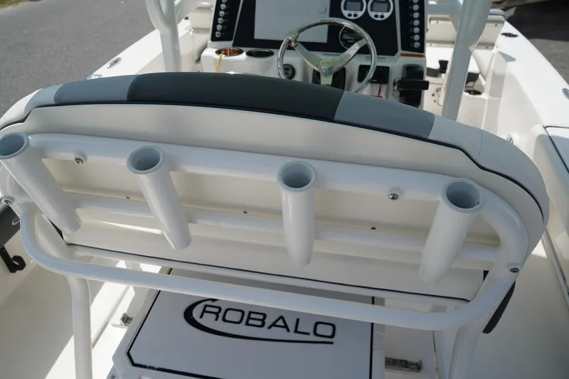 Slide: The Image of 2024 Robalo 226 Cayman boat interior with rod holders and console. - 19