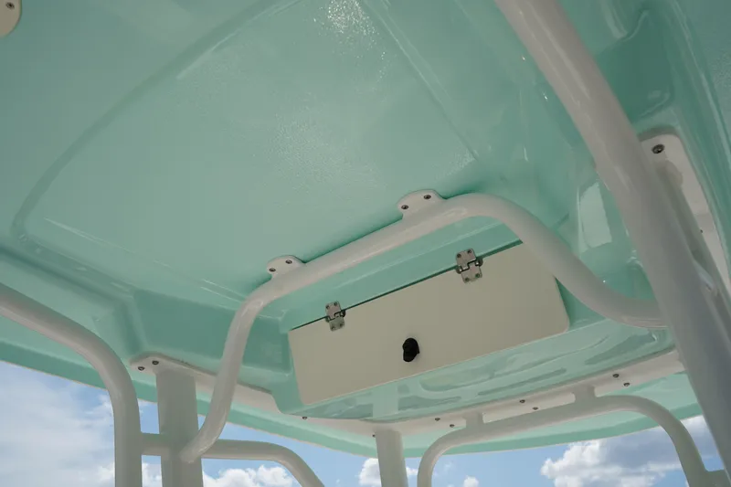 Slide: The Image of 2024 Robalo 226 Cayman boat interior ceiling with storage compartment. - 21