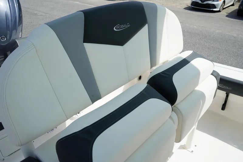 Slide: The Image of 2024 Robalo 226 Cayman boat seating with black and white upholstery. - 22