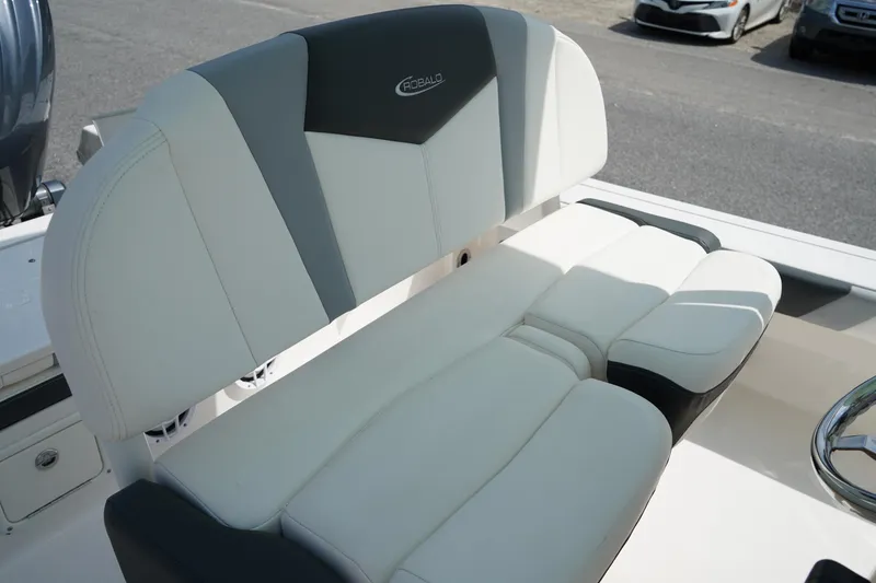 Slide: The Image of 2024 Robalo 226 Cayman boat seating, featuring white and gray cushioned design. - 23