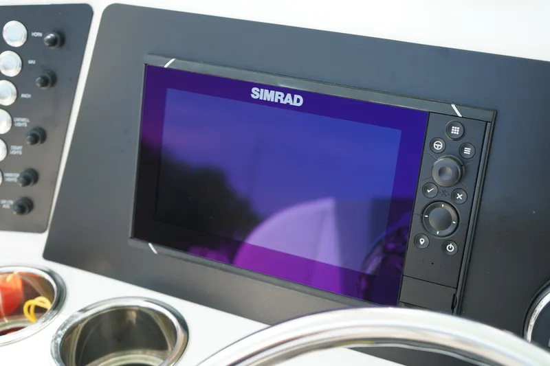 Slide: The Image of Simrad display on 2024 Robalo 226 Cayman boat dashboard with control buttons. - 28