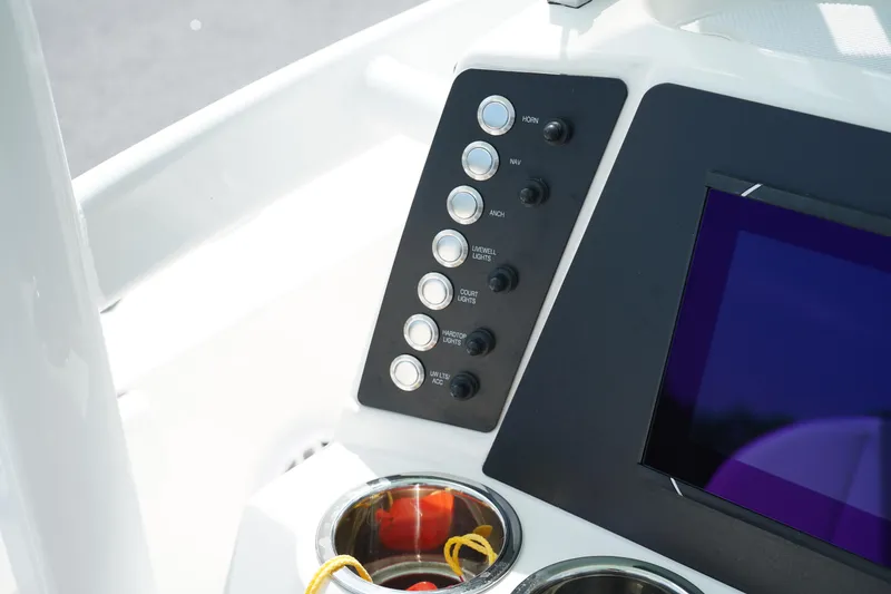 Slide: The Image of 2024 Robalo 226 Cayman boat dashboard with control panel and display screen. - 29