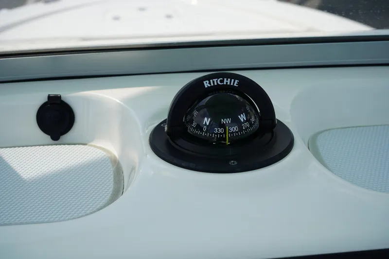 Slide: The Image of Compass on 2024 Robalo 226 Cayman boat dashboard, featuring Ritchie navigation. - 30