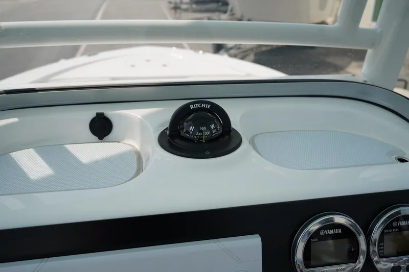 Slide: The Image of 2024 Robalo 226 Cayman dashboard with compass and Yamaha gauges. - 31