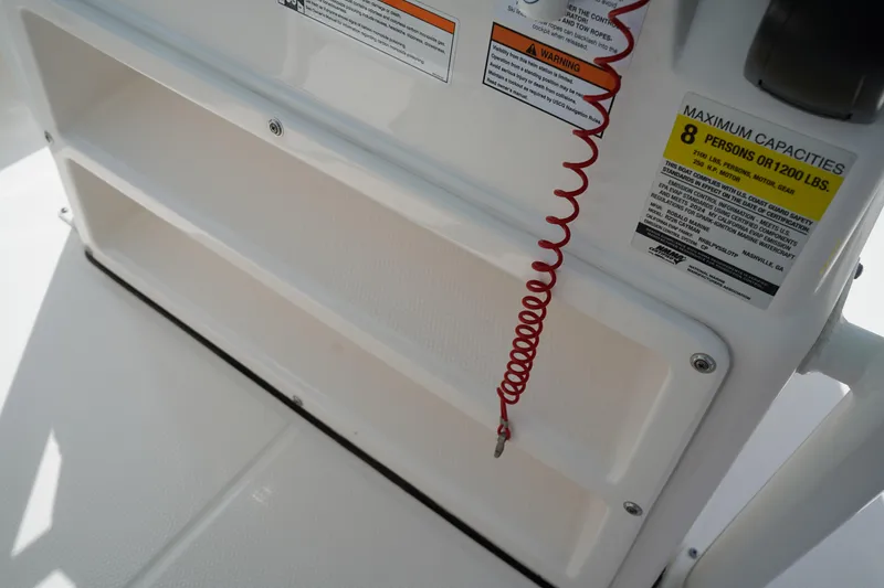 Slide: The Image of 2024 Robalo 226 Cayman boat console with safety warnings and capacity label. - 32