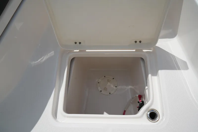 Slide: The Image of 2024 Robalo 226 Cayman boat storage compartment with open lid. - 38