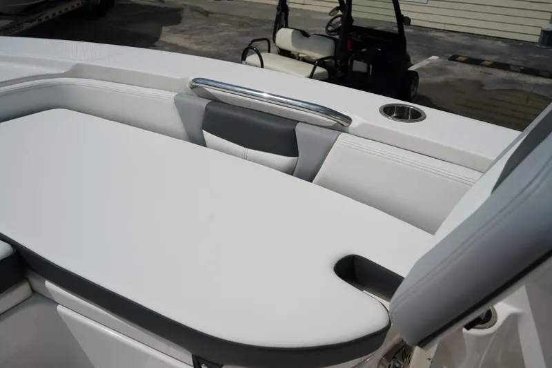 Slide: The Image of 2024 Robalo 226 Cayman boat interior with cushioned seating and cup holder. - 39
