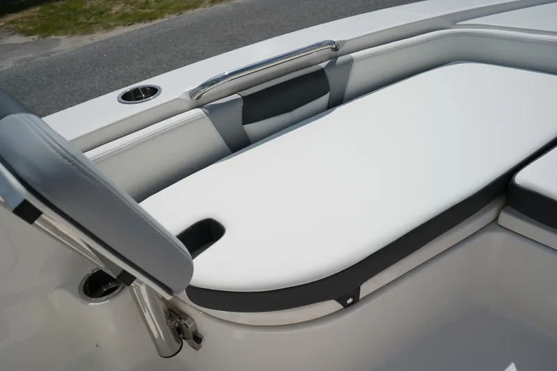 Slide: The Image of 2024 Robalo 226 Cayman boat interior with cushioned seating and stainless steel details. - 41