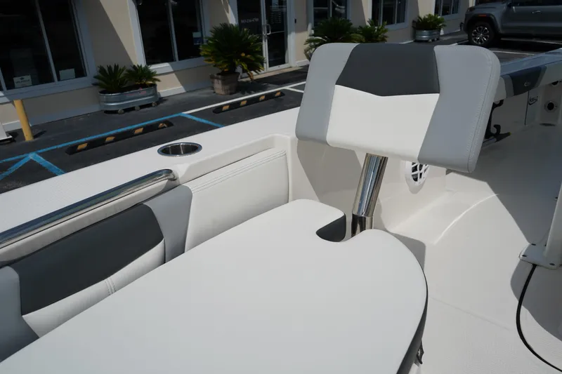 Slide: The Image of 2024 Robalo 226 Cayman boat interior with cushioned seating and cup holder. - 43