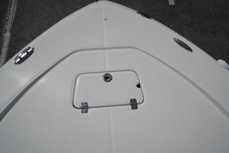 Slide: The Image of Bow deck of 2024 Robalo 226 Cayman boat with storage hatch and cleats. - 47