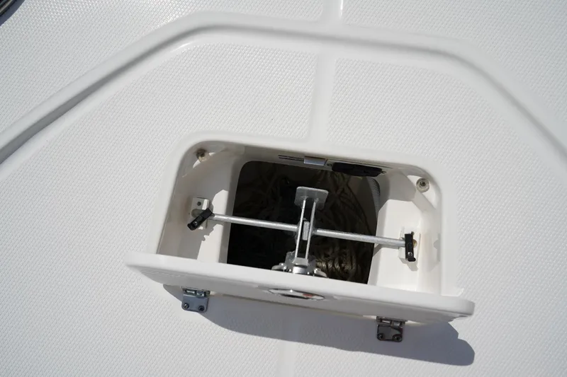 Slide: The Image of 2024 Robalo 226 Cayman anchor storage compartment with open hatch. - 48