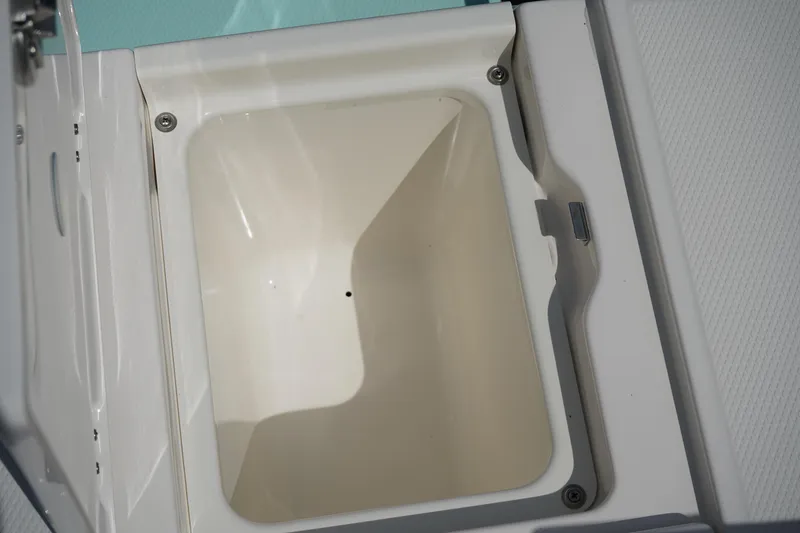 Slide: The Image of 2024 Robalo 226 Cayman storage compartment, open and empty, showcasing interior design. - 8