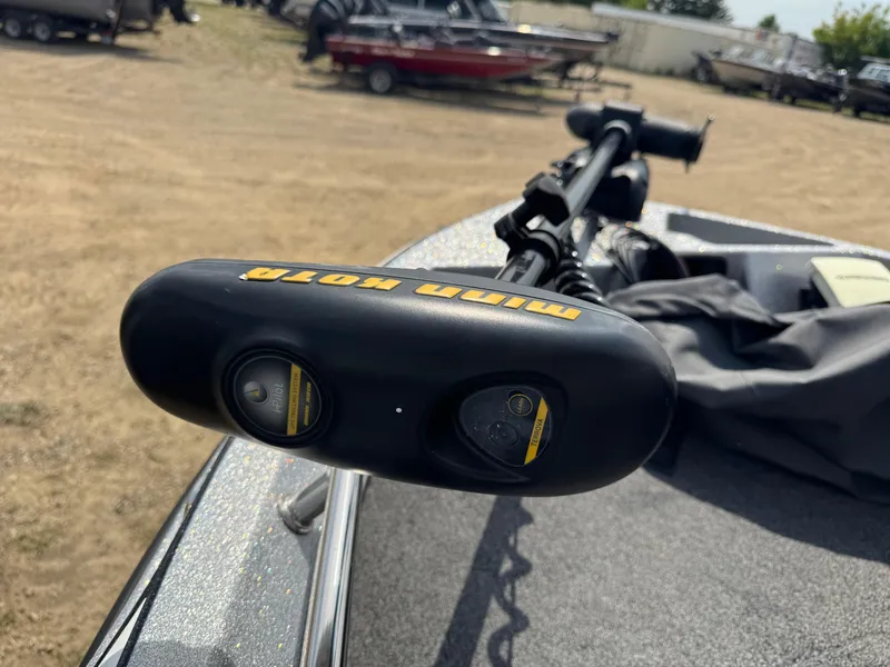 Slide: The Image of Trolling motor on a 2015 Nitro ZV 18 boat, parked in a lot with other boats. - 12