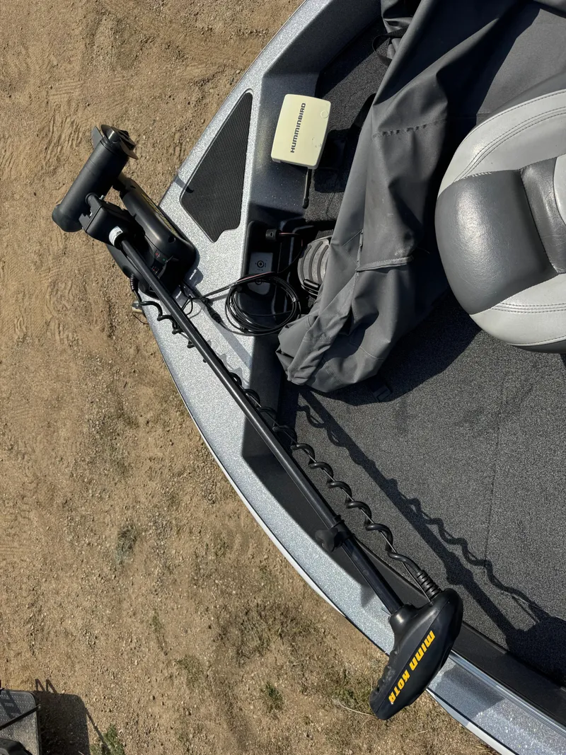 Slide: The Image of 2015 Nitro ZV 18 boat with Minn Kota trolling motor on sandy shore. - 13