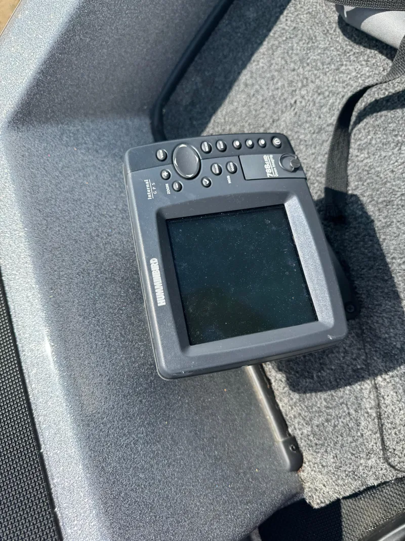 Slide: The Image of Fishfinder device on a 2015 Nitro ZV 18 boat, resting on a textured surface. - 14