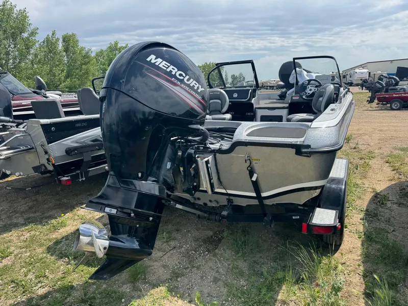 Slide: The Image of 2015 Nitro ZV 18 boat with Mercury outboard motor, parked on grass. - 3