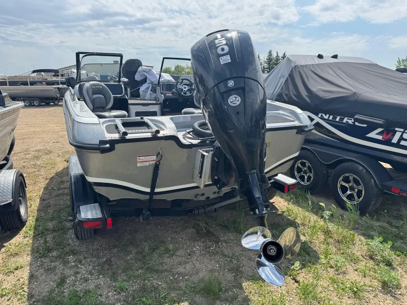 Slide: The Image of 2015 Nitro ZV 18 boat with outboard motor, parked on a trailer in a grassy area. - 4