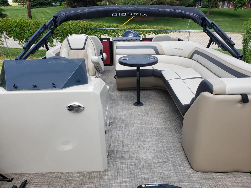 Slide: The Image of 2022 Viaggio 20F pontoon boat interior with seating and table. - 2
