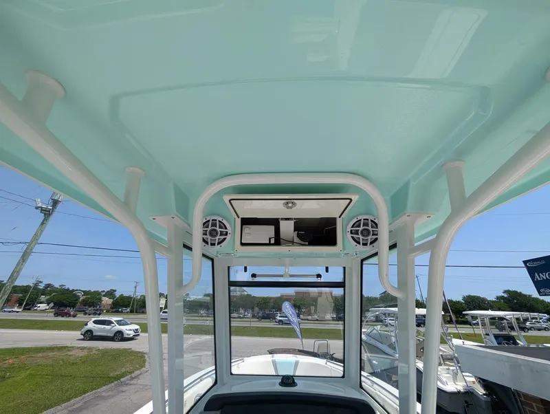 Slide: The Image of 2025 Robalo R250 Center Console boat interior with speakers and overhead storage. - 15