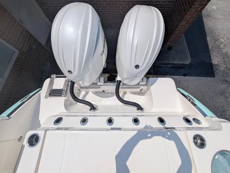 Slide: The Image of 2025 Robalo R250 Center Console boat with dual outboard engines, viewed from above. - 16