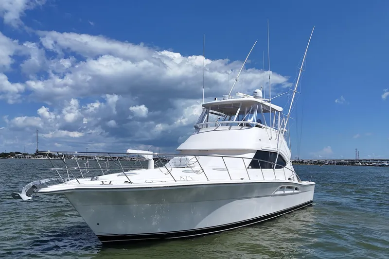 Slide: The Image of 2005 Riviera 47 Open Flybridge yacht on water under blue sky. - 10